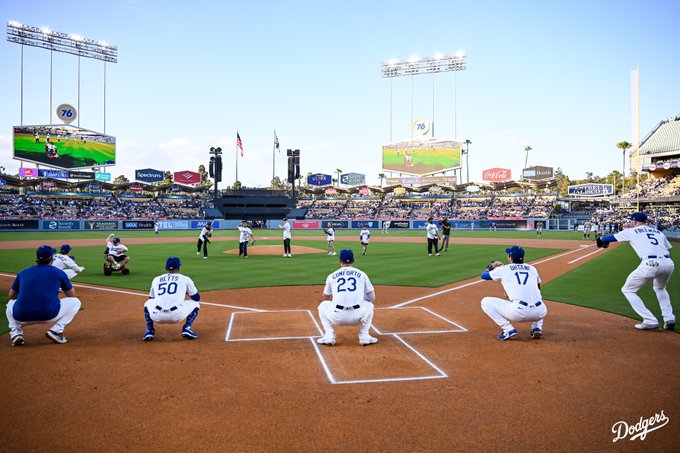 A photo of the seven children from Make A Wish America throwing out the first pitch to Clayton Kershaw, Mookie Betts, Michael Conforto, Shohei Ohtani and Freddie Freeman.