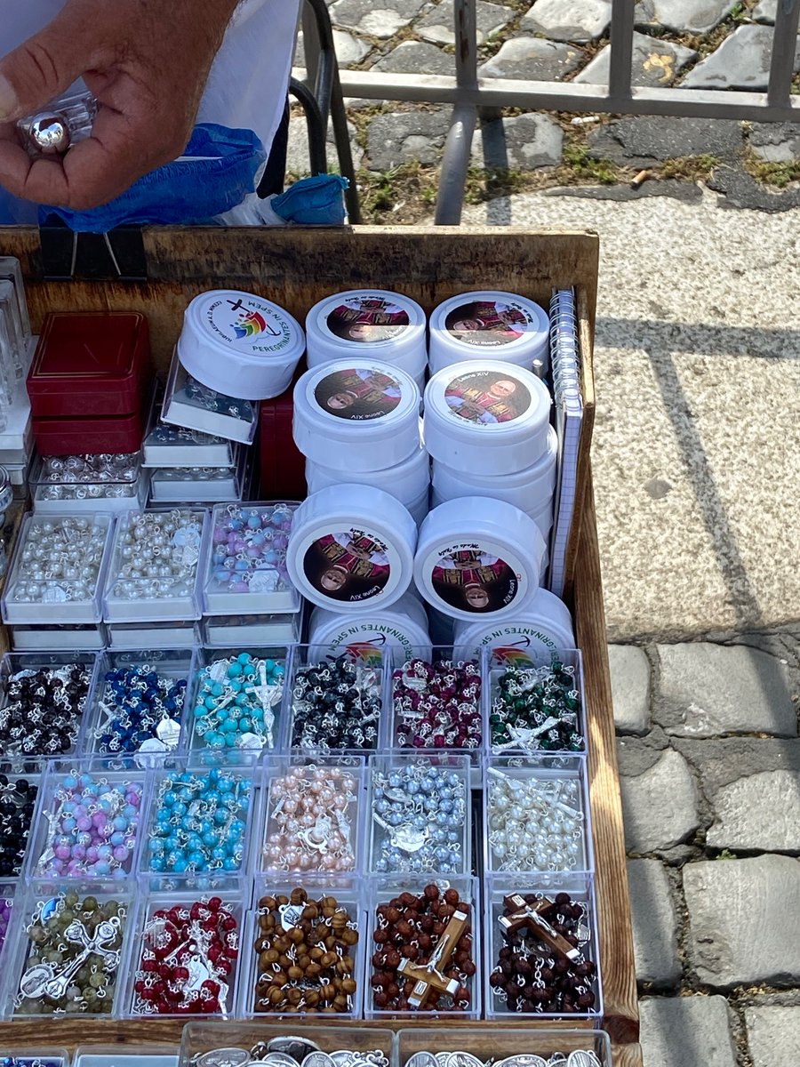 McLellan_Js's tweet image. First Pope Leo merch I’ve seen around the Vatican. Pope Francis rosaries “on sale” for one Euro.