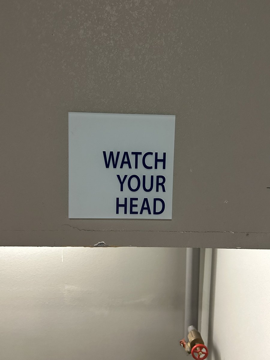 Pointless post:
Seen signs like this often but this time it really got me thinking how ridiculous the premise is…
How can I possibly “watch my head”? It’s a physical impossibility! My eyes r in my head. There’s literally no way I can watch my own head. 

Might be overthinking it