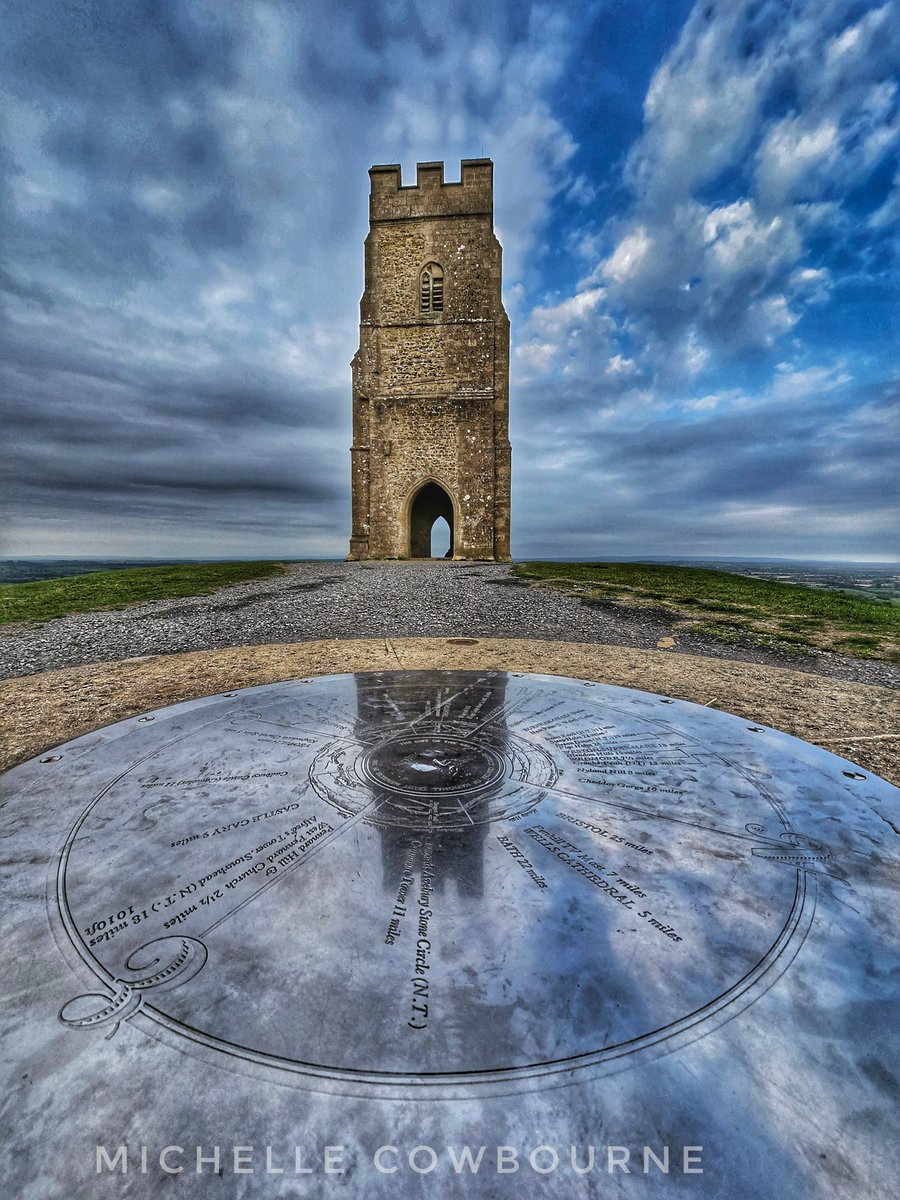 Reflection of St Michael's tower on the compass stone. Taken on Glastonbury Tor this morning.