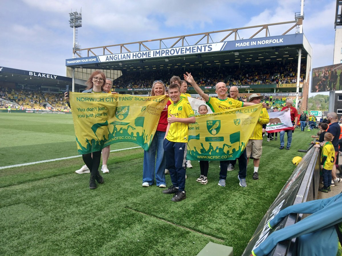 Our brilliant team displaying our flag at the half time parade at Carrow Road. They look so happy and rightly so particularly after the wonderful end of season Social Event which raised £1190 for <a href="/NorwichCityCSF/">Norwich City CSF</a>. Fantastic to join the other fans groups who all do amazing things.