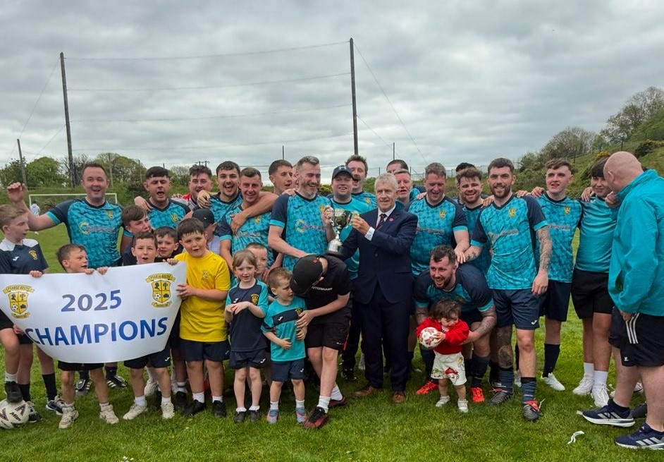 Congratulations to Pearse Celtic FC, who have won promotion from the Beamish Stout Junior 4th Division as League Champions. Well done to all involved. Photo: John Lyne, Munster Senior League, presents the 4th Division Trophy to Pearse Celtic captain Ryan O'Shea.