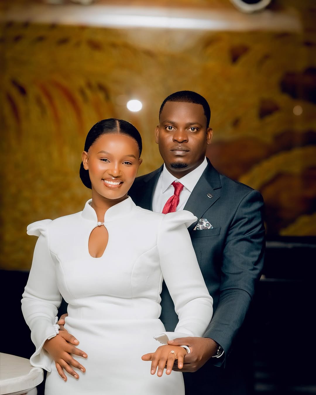 Vestine and Idrissa smiling as they prepare for their wedding