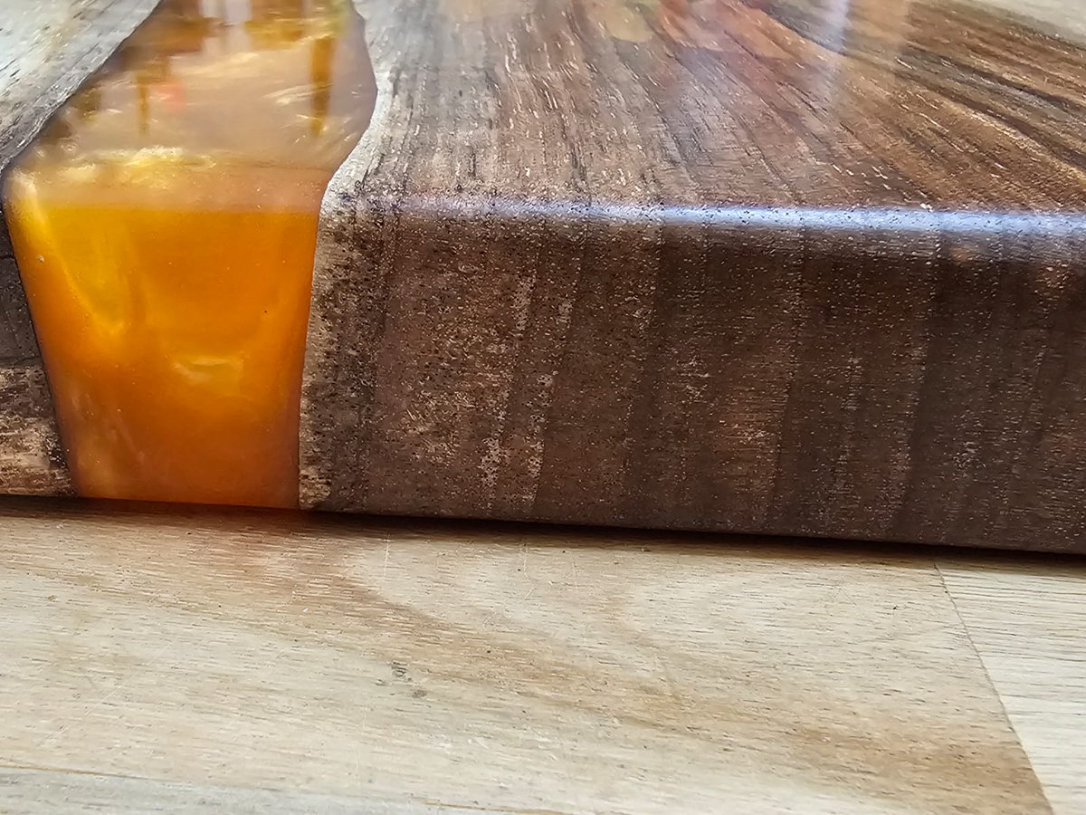 A bespoke, customised wedding gift. Amber resin river chopping board.