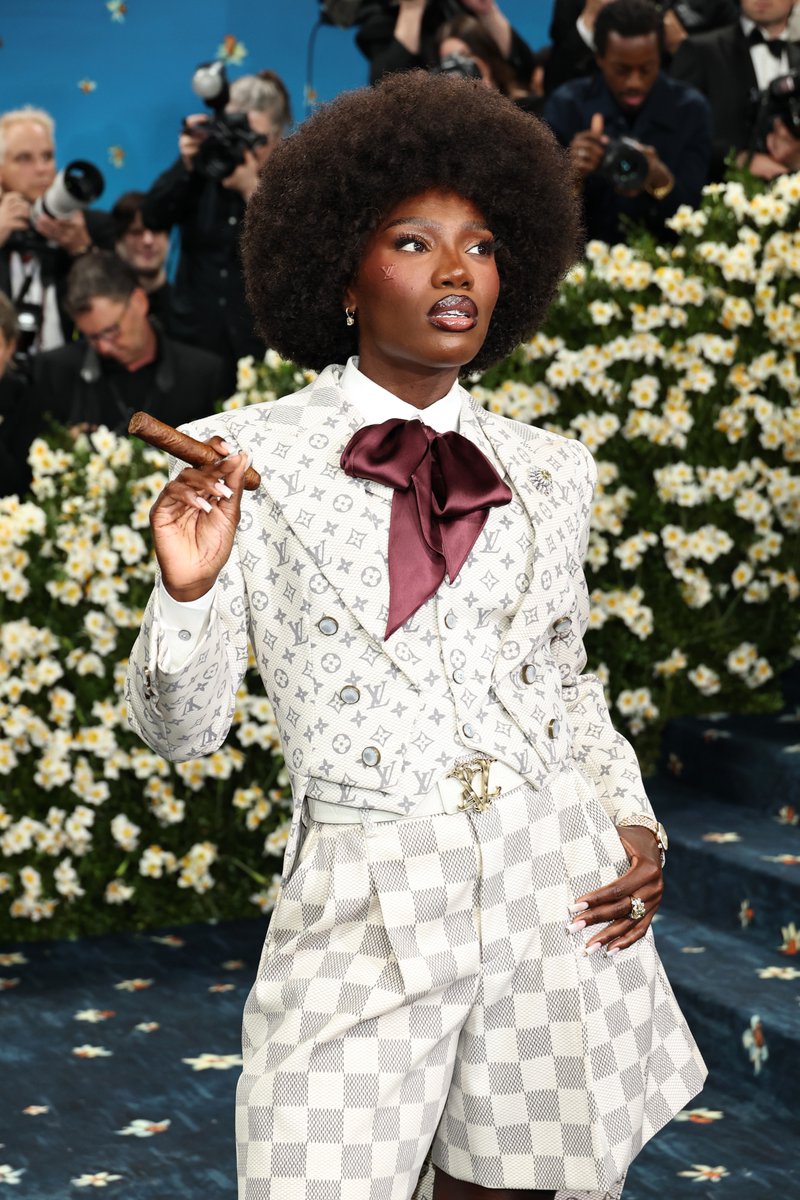 Doechii stunts with a cigar on the #MetGala carpet. variety.com/gallery/met-ga…