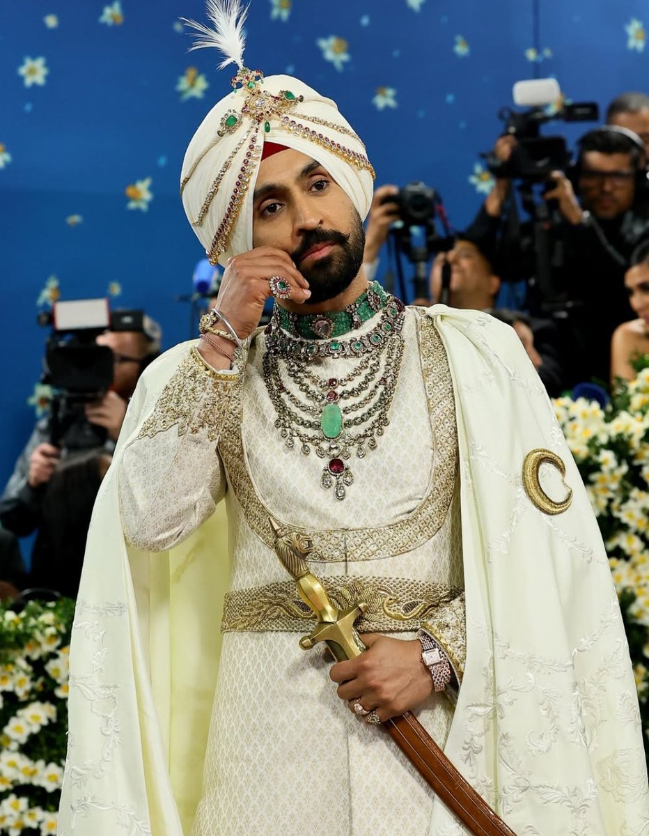 #DiljitDosanjh paid tribute to Patiala's Maharaja Bhupinder Singh. His cape added a more regal touch to his look.  It came with a golden embroidery of Punjab's map, along with Punjabi alphabets on it. 

#Trending #METGala2025 #METGala