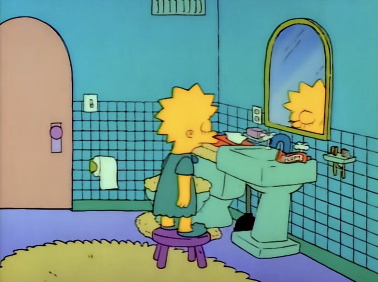Lisa looks at herself in the bathroom