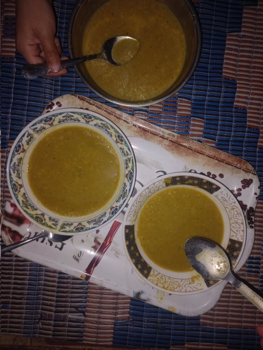 It is now 8:05 PM, and I’ve been searching for food for my family since this morning. Finally, I managed to find some lentils. My mother and I cooked them, and as you can see, these are just three plates for nine people — none of whom have eaten anything since the morning.
