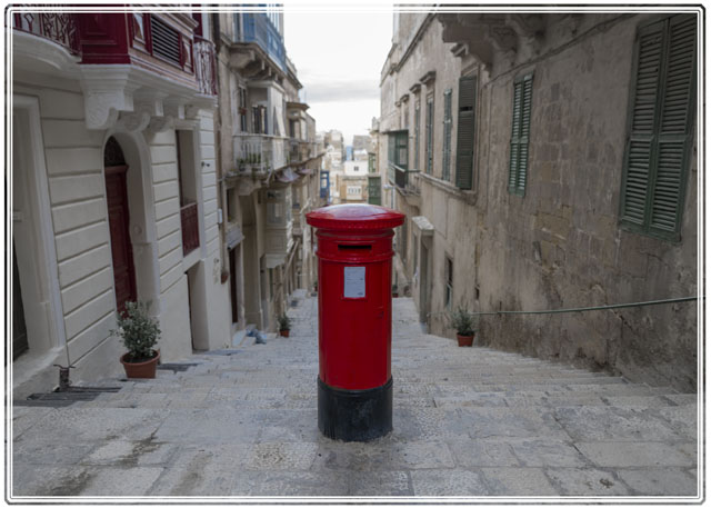 photos_dsmith's tweet photo. A @MaltaPost #postbox/#mailbox in the streets of #Valletta, #Malta. A vibrant red box stands out amongst the #architecure of the #city. It seems deliberately placed in the middle of the #alley so to be noticed. #streetphotography #urban #urbanphotography #travelscenes #streetart https://t.co/65wwu20iEy