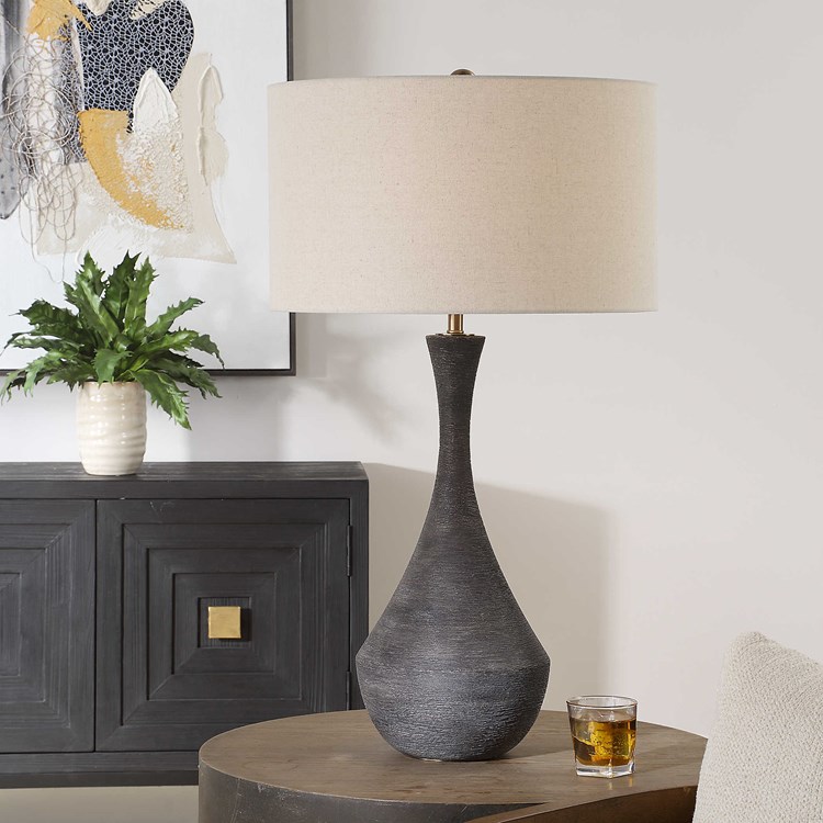In stock with fast free shipping from <a href="/LampsPlus/">Lamps Plus</a>, this ceramic table lamp features a heavy horizontal texture finished in a rustic dark charcoal glaze, accented with plated brass details. #carolynkinder lampsplus.com/products/utter…