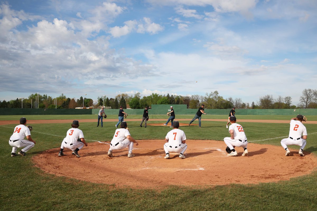 Dads are getting loose with their senior sons before throwing out the first pitch for our senior night. Thanks, Dads, for teaching us this great game.