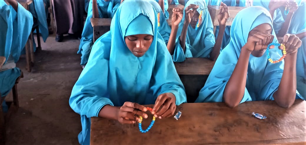 Adolescent girls in Lamu creating their own menstrual bracelets — simple yet powerful tools to track their cycles, start conversations, and break taboos. <a href="/IriseEastAfrica/">Irise Institute East Africa</a>  
#PeriodEquality #MenstrualHealth #LetGirlsThrive #LamuGirlsLead