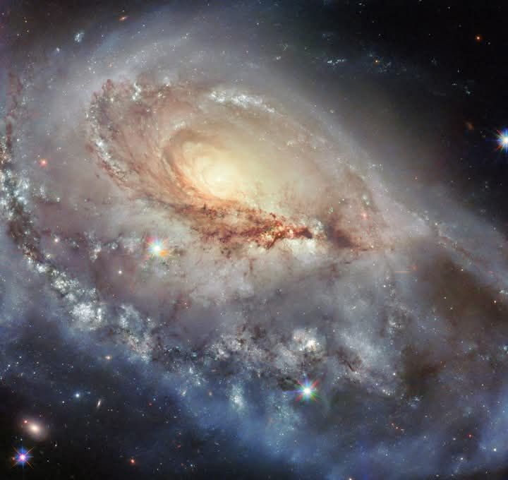 A beautiful but skewed spiral galaxy dazzles in this image from NASA's Hubble Space Telescope. The galaxy, called Arp 184 or NGC 1961, sits about 190 million light-years away from Earth in the constellation Camelopardalis (The Giraffe).