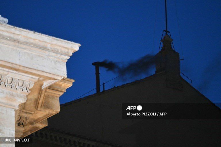 black smoke rising from the chimney of the Sistine Chapel signalling that cardinals failed to elect a new pope in the first ballot of their conclave in the Vatican