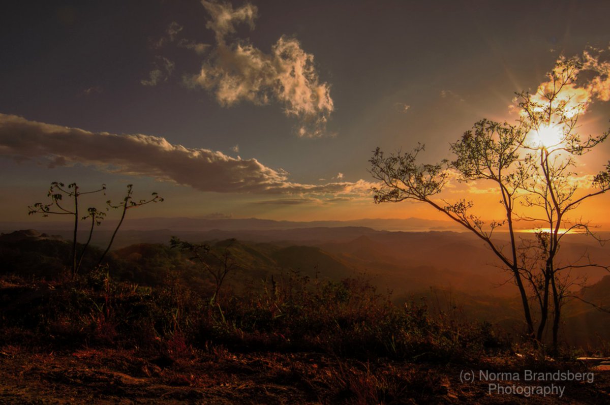 Costa Rica, stunning orange vista sunsets &amp; sunrises! Sugarcane field burning in January creates spectacular mountain clouds, lighting and translucent sky landscape photo opportunities.