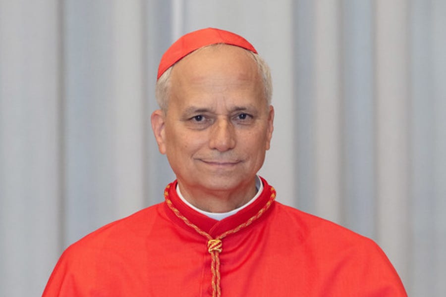 FIRST AMERICAN POPE! The identity of the new pope has been revealed as Robert Francis Prevost. He will now deliver his first public address and blessing to the gathered crowds in St Peter's Square.