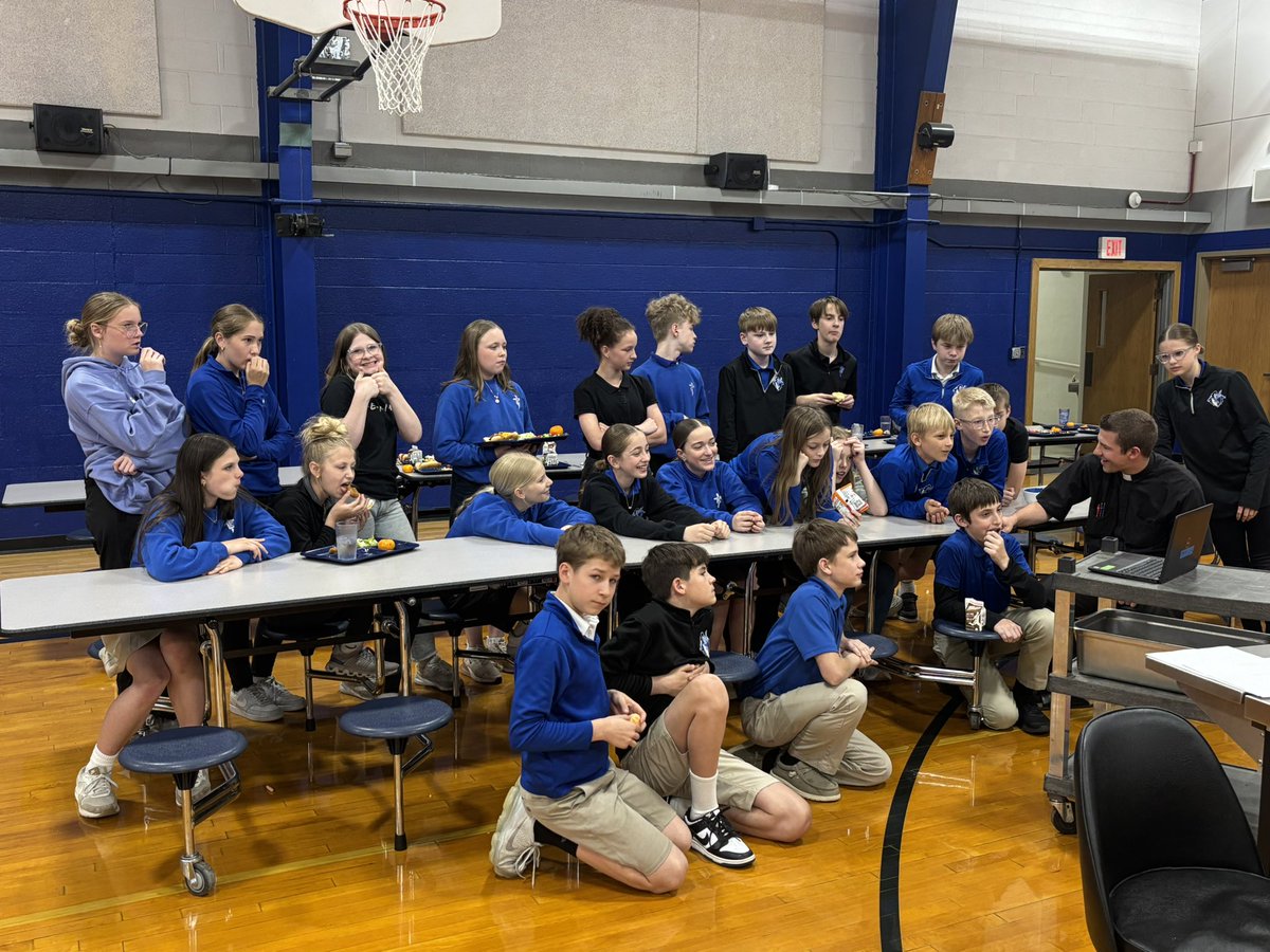 Middle school students with Fr. Brox awaiting the announcement of our new pope during lunch! 💙