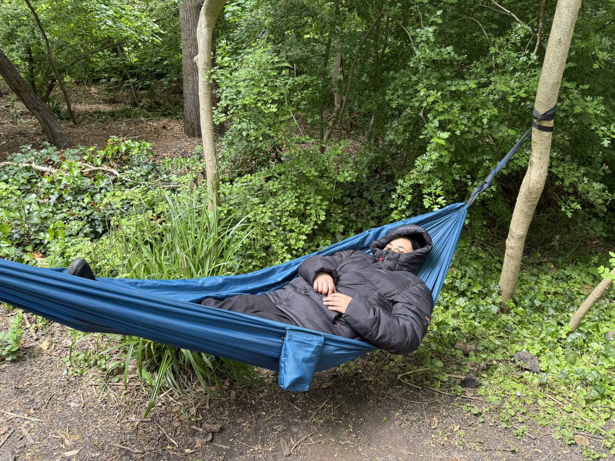 HaringeyLP's tweet image. After an afternoon of exploring, crafting, and climbing, one student finds the perfect way to unwind—gently swaying in the hammock beneath the trees. 🌳😌 #ForestSchool #ThisIsAP