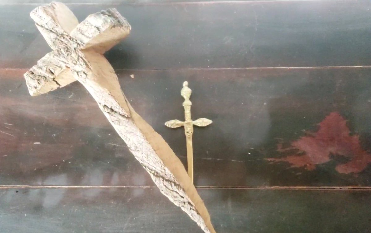 The wood - symbology of the instruments of God's Creation like Noah's Ark.  The wood is a natural humble material.  Also symbolizing the Tree of Life.  God is collecting a family and Jesus heads up that family and gives eternal life to God's chosen Children.

Love you all