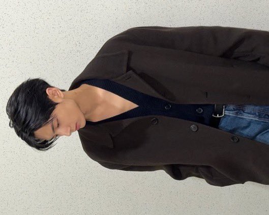 The rich, intense color flows effortlessly in this luxurious dark brown coat from Prada, and the brand's ability to blend art with everyday fashion allows for a casual look that maintains high fashion excellence.