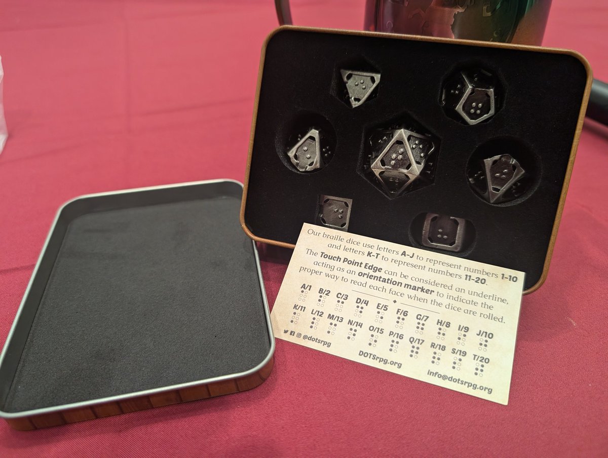 GrinningHazard - Same name on blsky (@grinninghazard) on Twitter photo Have you guys heard about? <a href="/DOTSrpg/">DOTS RPG Project</a> ?
They're a 501c3 non-profit org making Braille dice and other accessibility options for tabletop at role-playing games. I picked this set of hollow metal Braille dice for next year's extra life. Go check them out!!
#PAXEast2025 #PAXEast Have you guys heard about? <a href="/DOTSrpg/">DOTS RPG Project</a> ?
They're a 501c3 non-profit org making Braille dice and other accessibility options for tabletop at role-playing games. I picked this set of hollow metal Braille dice for next year's extra life. Go check them out!!
#PAXEast2025 #PAXEast