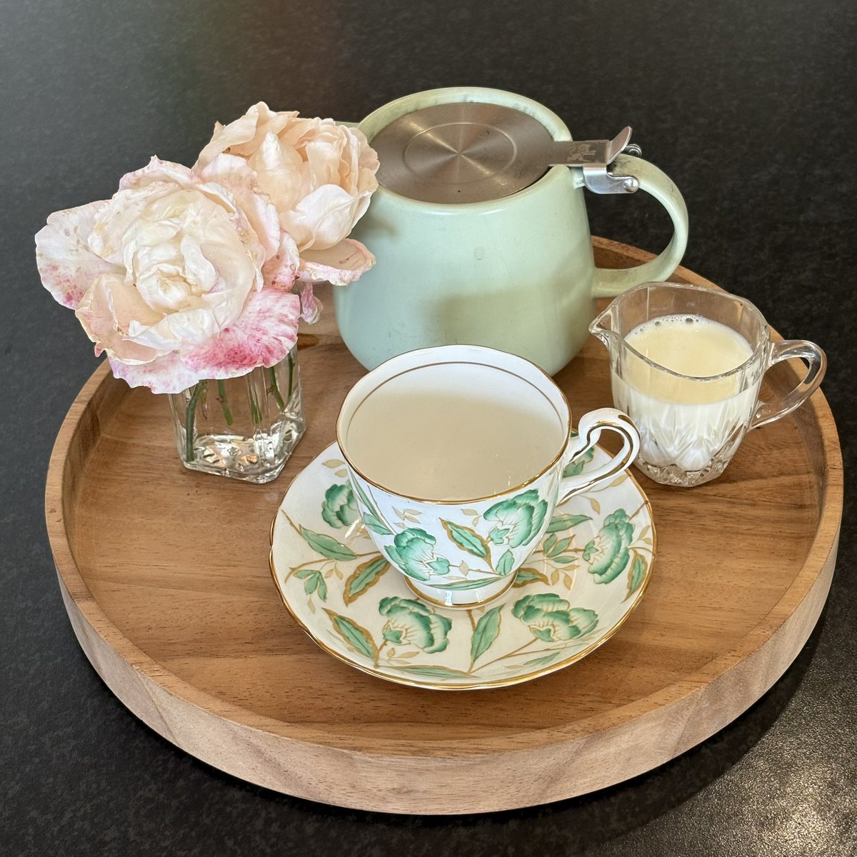 Some very battered roses in need of a tea tray