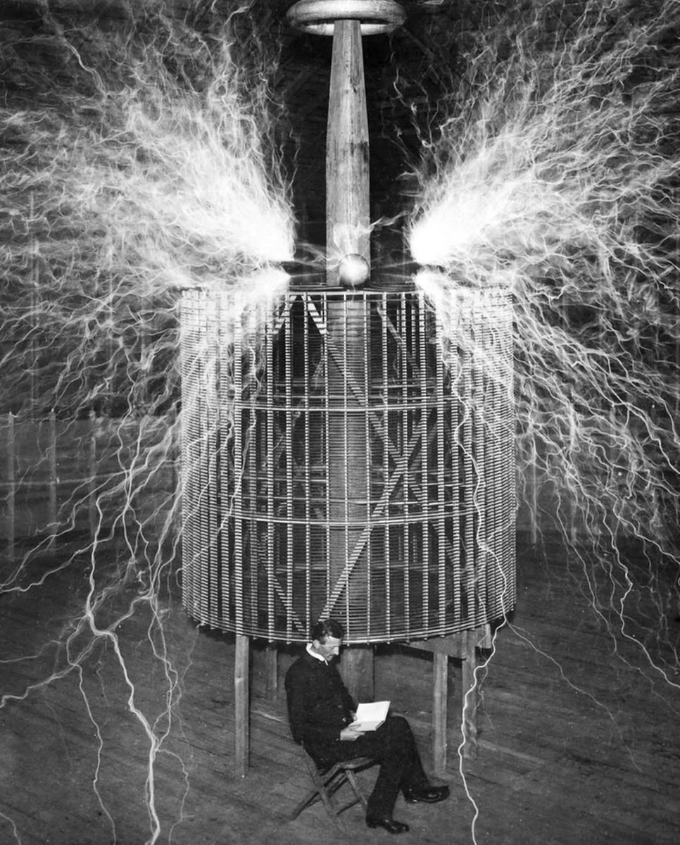 HistoryInPics's tweet photo. In 1899, Nikola Tesla set up a lab in Colorado Springs to explore wireless energy and high-voltage electricity.

One of the most iconic images from that time shows him calmly sitting beneath giant arcs of electricity—a double exposure meant to showcase his revolutionary experiments.

Tesla’s work there produced artificial lightning, lit lamps wirelessly, and even captured strange signals he believed might be from space.

Though the lab was later dismantled, his groundbreaking research helped shape the future of electrical engineering.