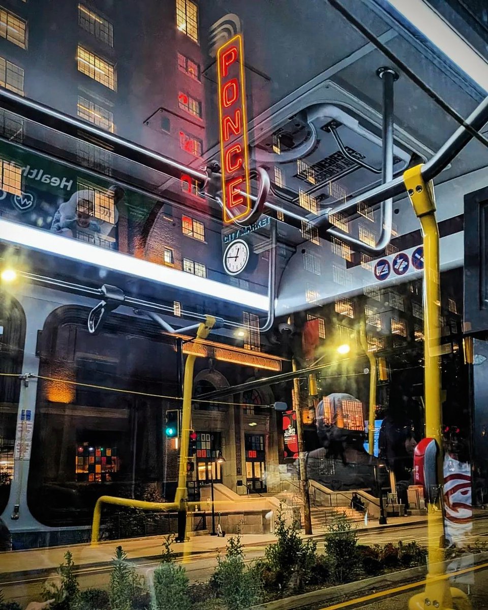 Looking at Ponce City Market from inside a bus at night. About eight people got on my 102 bus tonight at the Ponce City Market stop! That made me happy. Ride the bus! Watching the city go by from one of these big windows is nice.