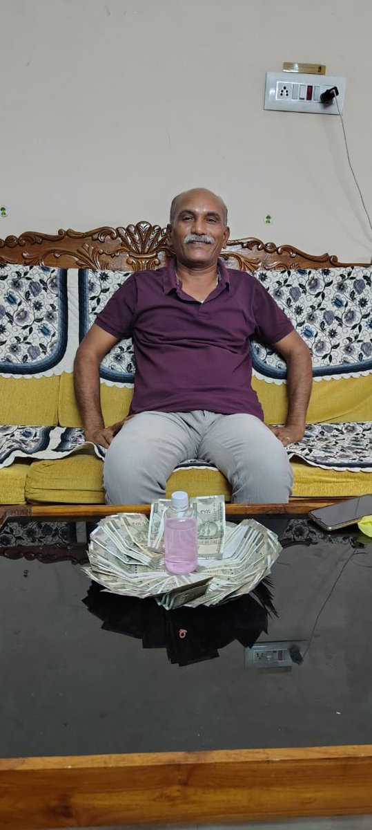 sudhakarudumula's tweet photo. Look at this corrupt babu — how royally he sits! His name: Arram Reddy Amarender. He is Aram even after caught

Executive Engineer of Sircilla Irrigation Division Caught Red-Handed with Bribe

ARRAM REDDY AMARENDER REDDY, EXECUTIVE ENGINEER, IRRIGATION, SIRCILLA, RAJANNA SIRCILLA DISTRICT — now in the ACB net.

On the night of May 9, 2025, around 8:00 PM, ACB Karimnagar officials caught the accused officer red-handed at his residence in Vidyaranyapuri, Karimnagar). He had just accepted a bribe of Rs. 60,000 from a contractor. The bribe was demanded to sanction a pending bill of Rs. 50 lakhs related to a check dam construction between Avunuru and Agraram villages in Venkatapur mandal, Rajanna Sircilla — a project completed nearly a year ago.

In a desperate attempt to mislead officials, the officer stuffed the bribe cash into his son’s T-shirt and flung it over the compound wall. ACB sleuths, however, recovered the tainted currency from behind the house, and the T-shirt portion that touched the notes tested positive in chemical verification.

This wasn’t his first time. The accused officer had earlier extorted Rs. 4 lakh from the same complainant for partial bill clearance and now sought another Rs. 75,000 for releasing the remaining payment.

He has been arrested and will be presented before the Special Judge for SPE & ACB Cases, Karimnagar. Investigation is ongoing. The identity of the complainant remains confidential for safety reasons.

To report corruption: Call ACB’s toll-free number — 1064.

#Telangana #Corruption