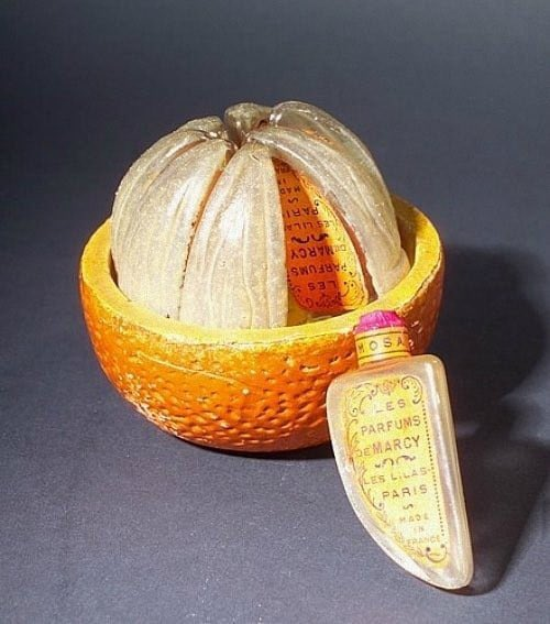 6/ A perfume bottle consisting of eight small glass bottles shaped as orange segments, ca. 1925