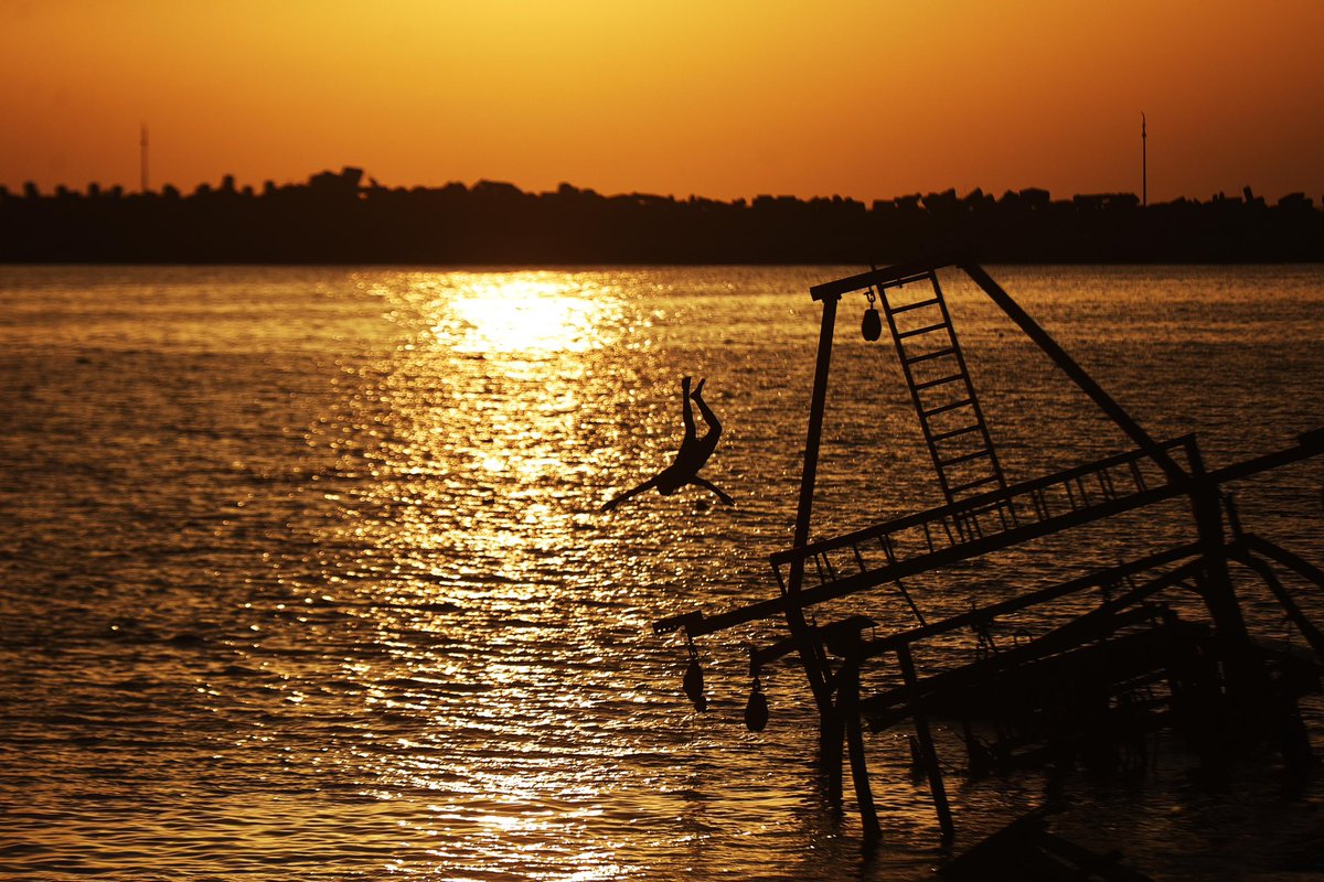 Palestinians, struggling with harsh living conditions due to ongoing Israeli attacks on the Gaza Strip and an intensifying heatwave, gather on the coast to cool off, spending the evening hours by the seaside to escape the stifling heat inside their tents in Gaza City, Gaza on May