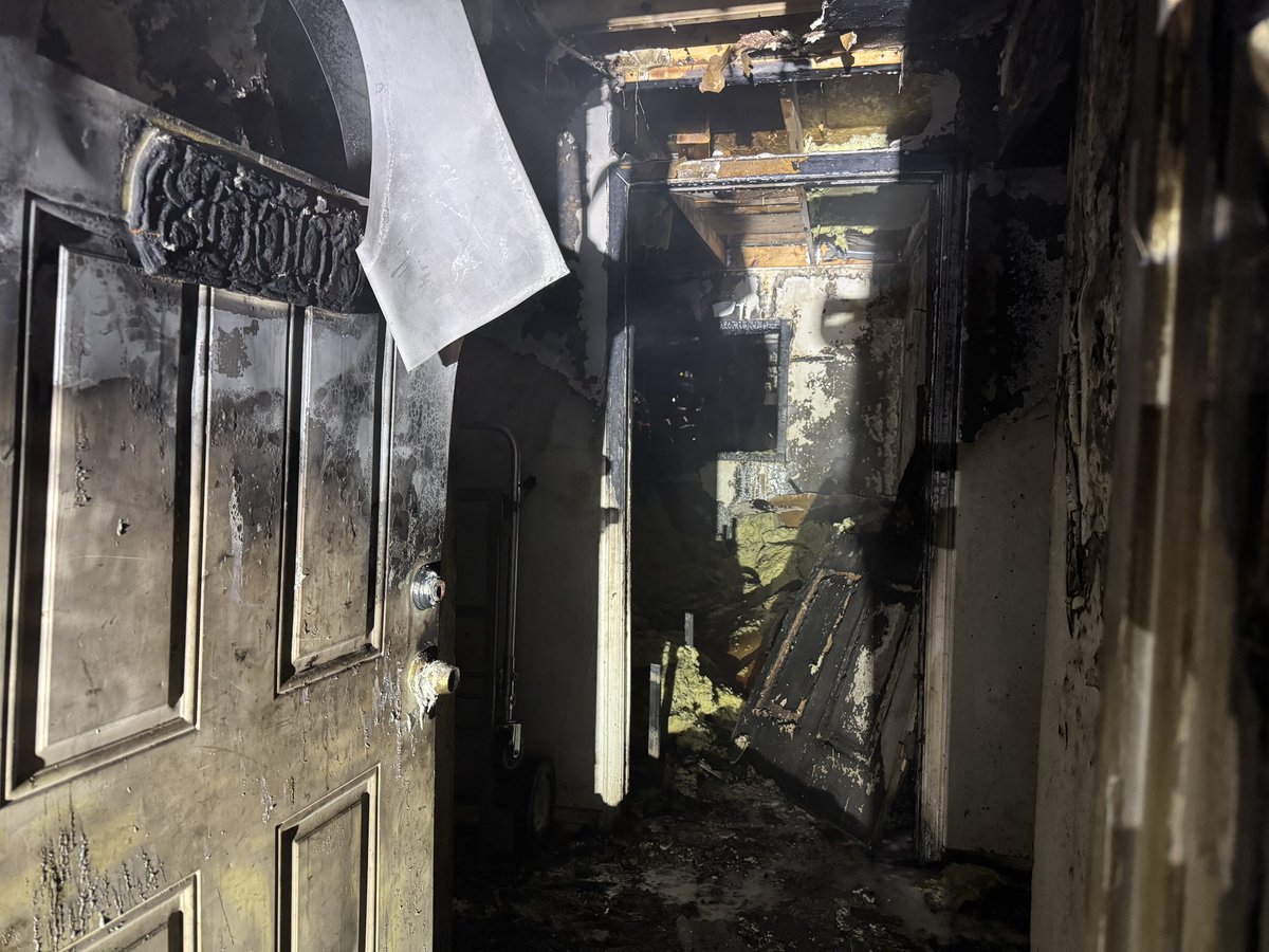 UPDATE: The garage had been converted to a living space, no one was home at the time of the fire. A neighboring home sustained some damage from heat exposure. The cause of the fire is under investigation.