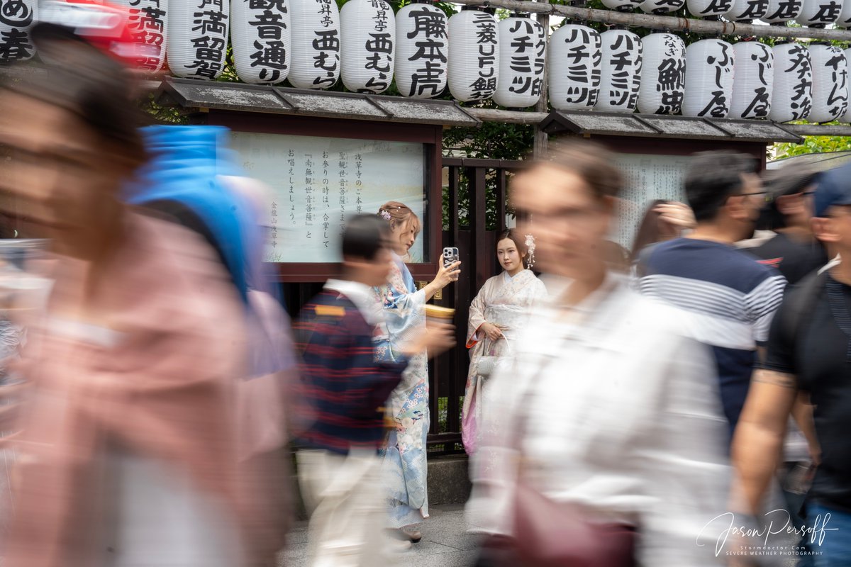 Near the Senso-Ji Temple in Asakusa is a bustling path filled with shops and crowds. I liked this street photo showing these women holding still in the market for IG photos while the crowds bustled past. #sensoji #Japan