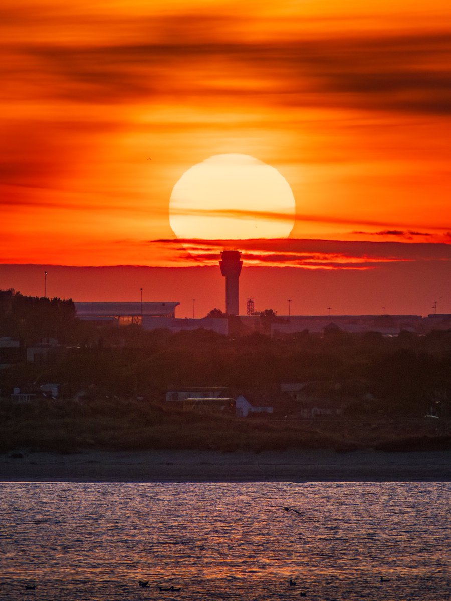 sryanbruenphoto's tweet image. Sunset aligned with Dublin Airport air traffic control tower.