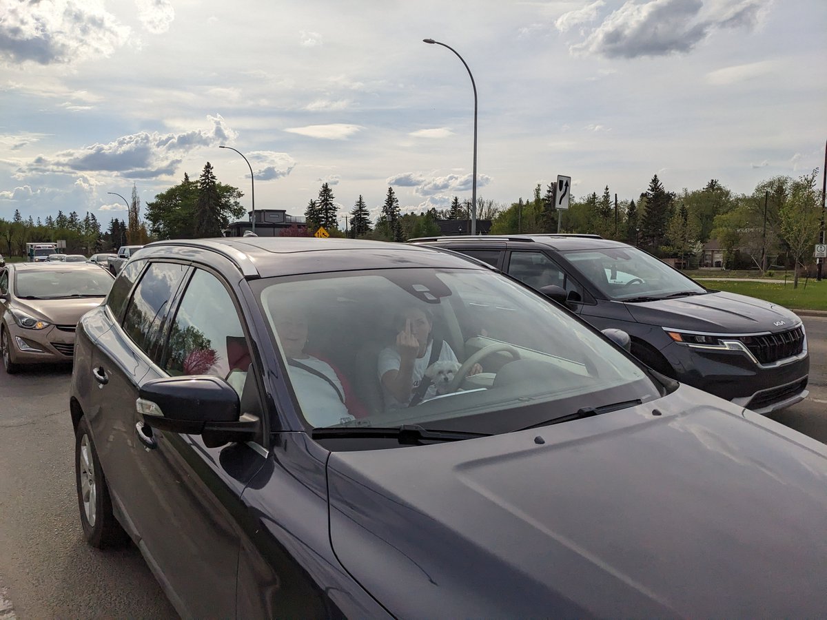 Average interaction with #yegtraffic here in #yeg, this lady with a dog on her lap stopped entirely on the crosswalk (well past every other stopped car) and when I merely gestured to the stop line she started yelling incoherently and giving me the finger