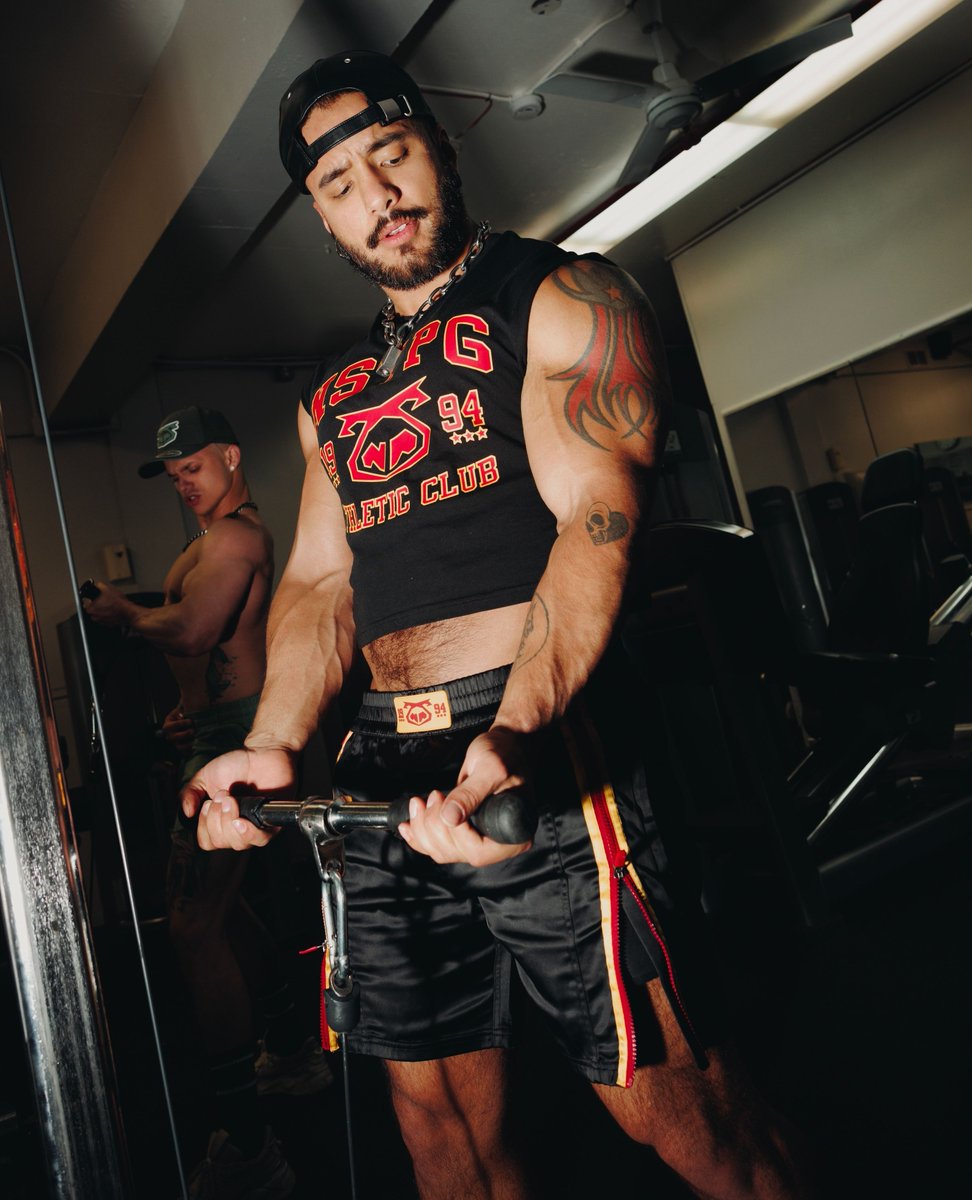 The Contender Sleeveless Crop Top and Contender Short, the ultimate tag team for showing off muscle and attitude. The crop hits high and tight, with our bold NSTPG 1994 stamp—pair it with the MMA-inspired shorts, decked out in red &amp; gold with side zips that scream "come get it."
