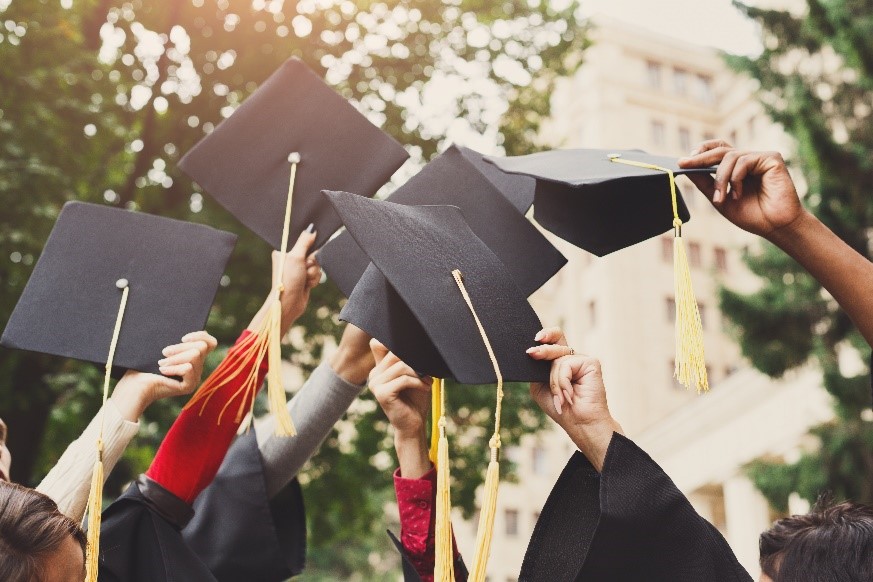 Student reaching for a graduation cap, symbolizing academic opportunity and success