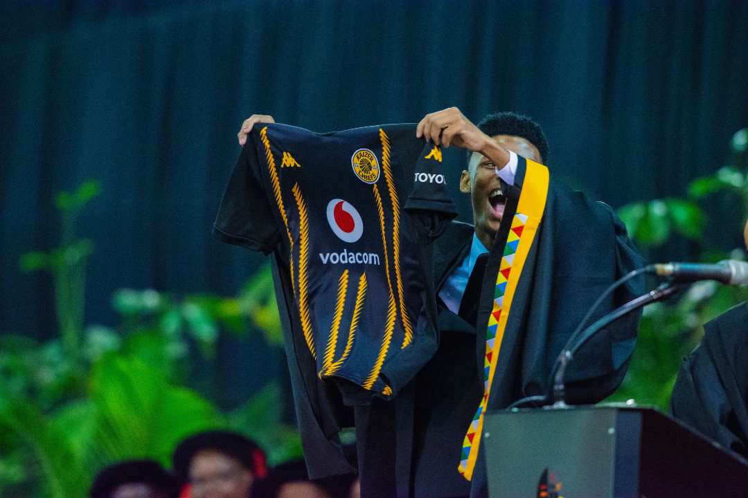Soccer fever at UKZN Graduation: A jubilant fan, Thobeka Zuma walked onto the graduation stage holding up a Kaizer Chiefs shirt to express his joy after the team won the Nedbank Cup Final at the weekend.

#UKZNGrad2025 #UKZN #InspiringGreatness #AfricanSchorlaship