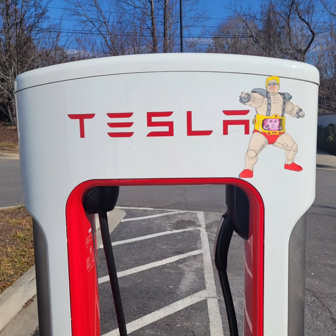 Anti-Trump/Elon sticker on a Tesla charging station