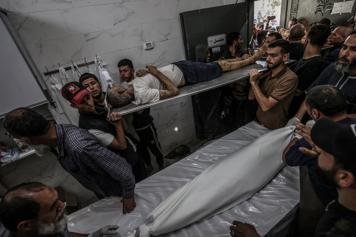 Families receive the bodies of their loved ones who were killed in Israeli attacks on various areas in the northern Gaza Strip, following funeral procedures at Al-Shifa Hospital in Gaza City, Gaza, on May 26, 2025. Grieving Palestinians mourned their loss. (Photo by Ali