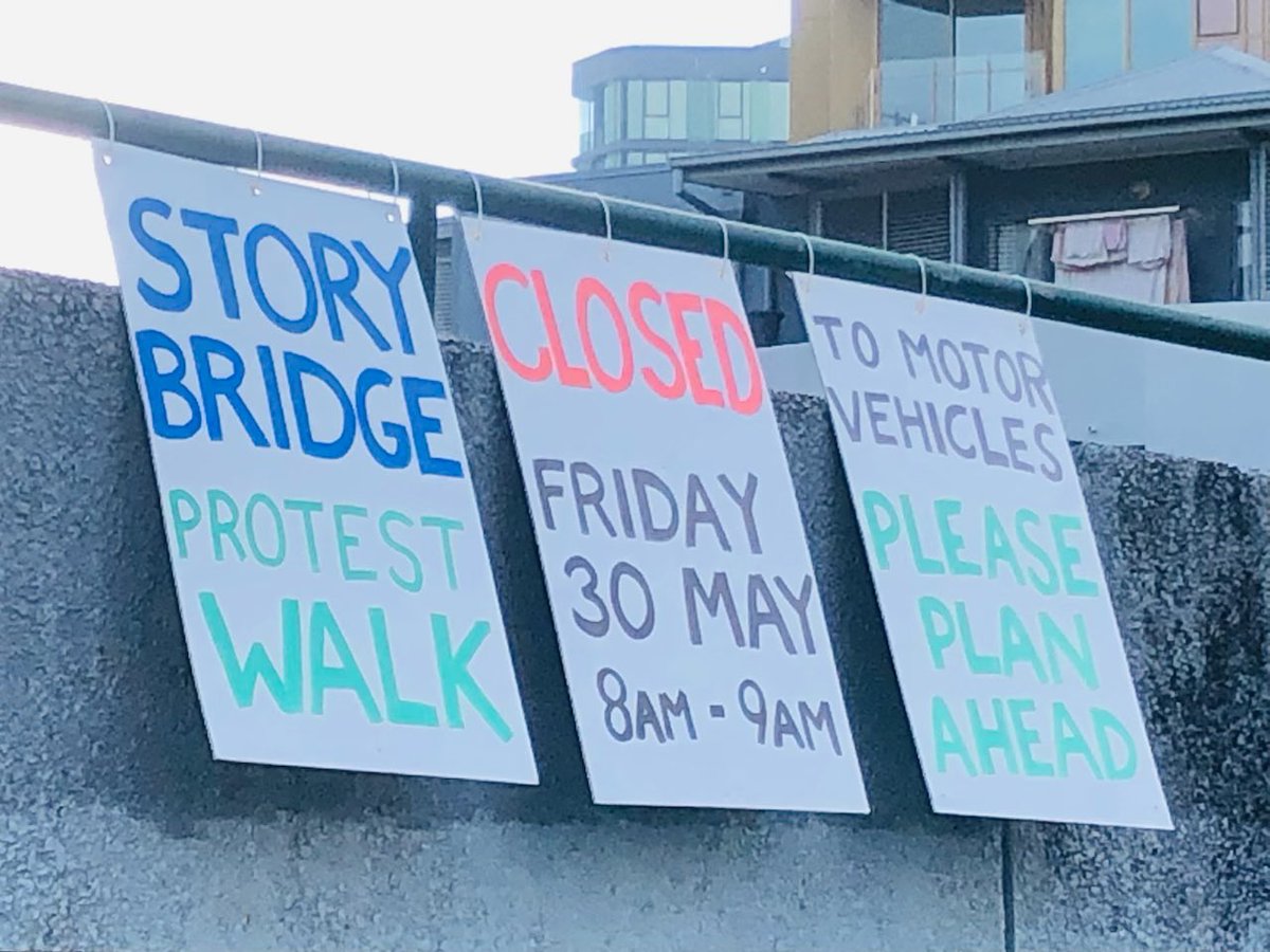 Signs on overpass for the Story Bridge planned protest this Friday