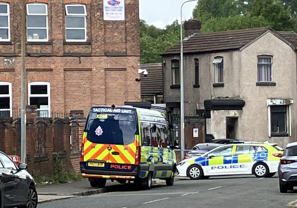 Several police vehicles including a tactical aid unit are inside the cordon. <a href="/MENnewsdesk/">Manchester News MEN</a>