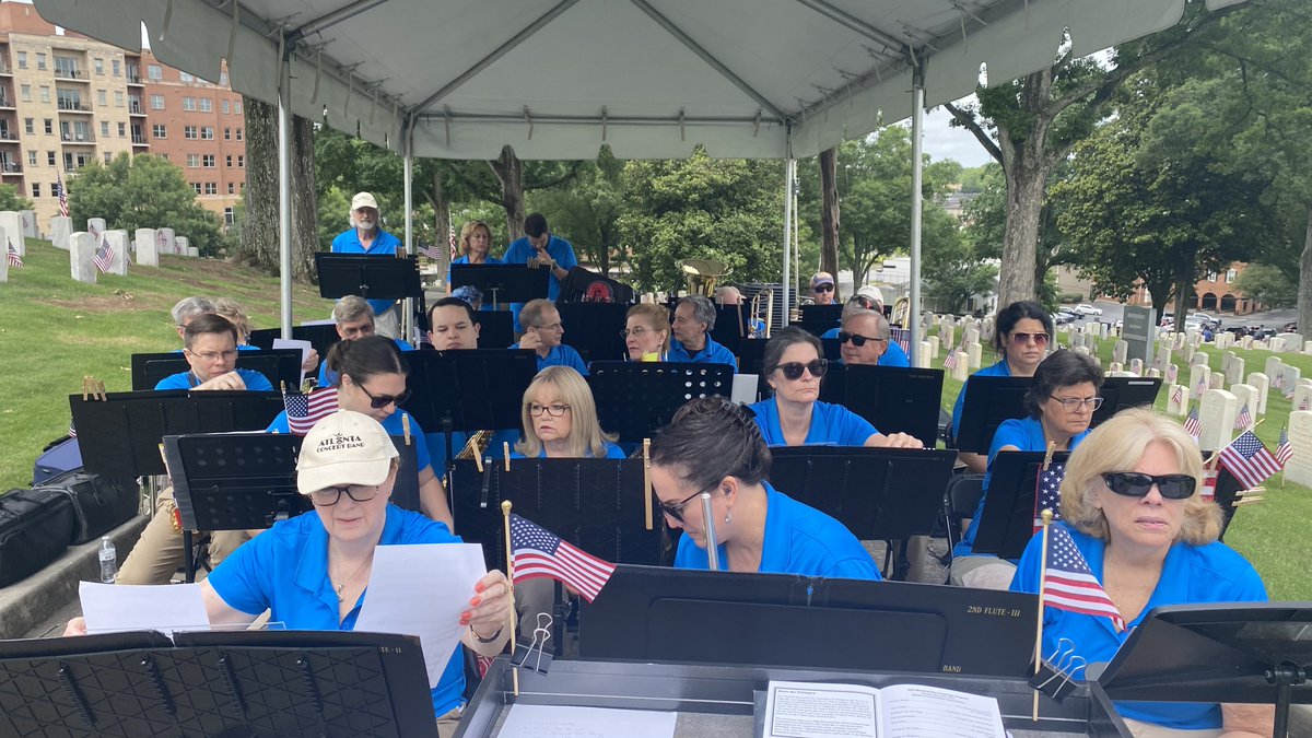 ATLConcertBand's tweet photo. 27 members of our band squeeze under a tent at the Marietta National Cemetery for #MemorialDay https://t.co/cHTnOrK9OD