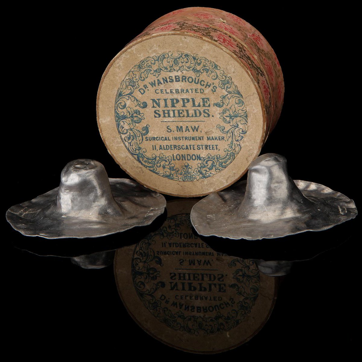 A pair of "Dr. Wansbrough's Celebrated Nipple Shields," lead breastfeeding protectors manufactured by S. Maw, London, in 1864.