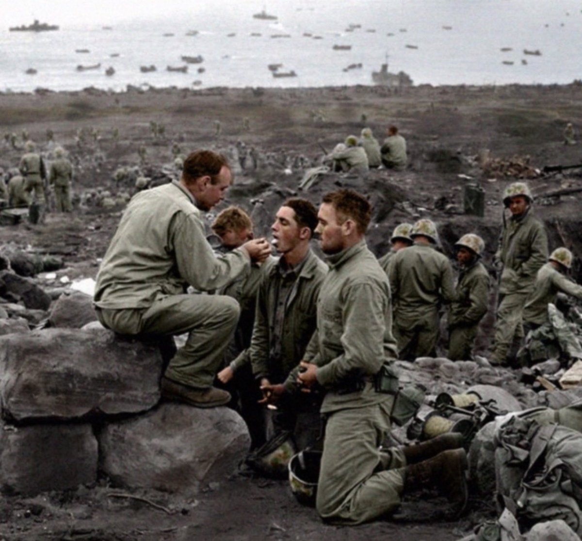 MilitaryCooI's tweet image. Marines receive communion, 1945, on Iwo Jima.