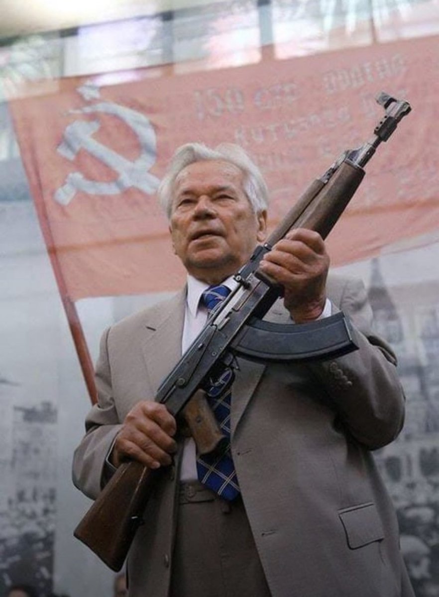Mikhail Kalashnikov holding the first AK prototype.