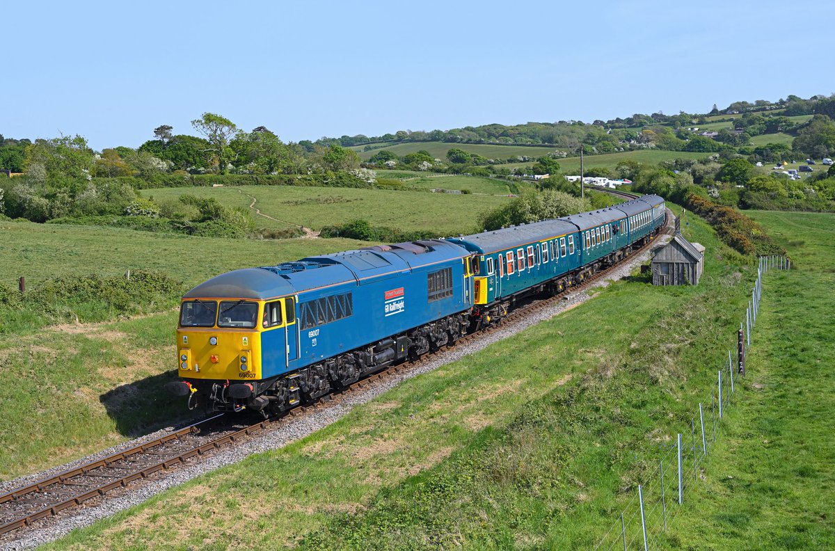 Looking fantastic with matching rail blue 4-VEP 3417 'Gordon Pettitt' in tow, 69007 (ex-56037) 'Richard Trevithick' ambles through Woodyhyde on 10th May 2025 with the 1N28 15:45 Swanage to Norden service. Taken during the Swanage Railway's Spring diesel gala event.