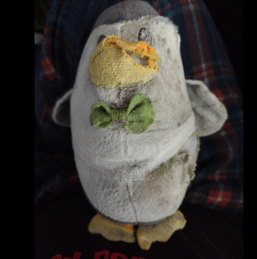 After many thousands of miles, riding on the front of my motorcycle in all weathers, Bubbles is looking somewhat battered and starting to come apart.

How much of him can I repair/replace before he ceases being Bubbles and becomes the Philosopher's Penguin?
