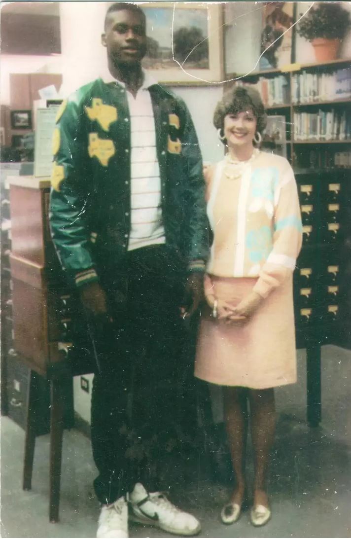 Shaquille O'Neal with school librarian Sandee Mewhinney at San Antonio's Robert G. Cole High School, 1989. Note how large his shoes are compared to hers.