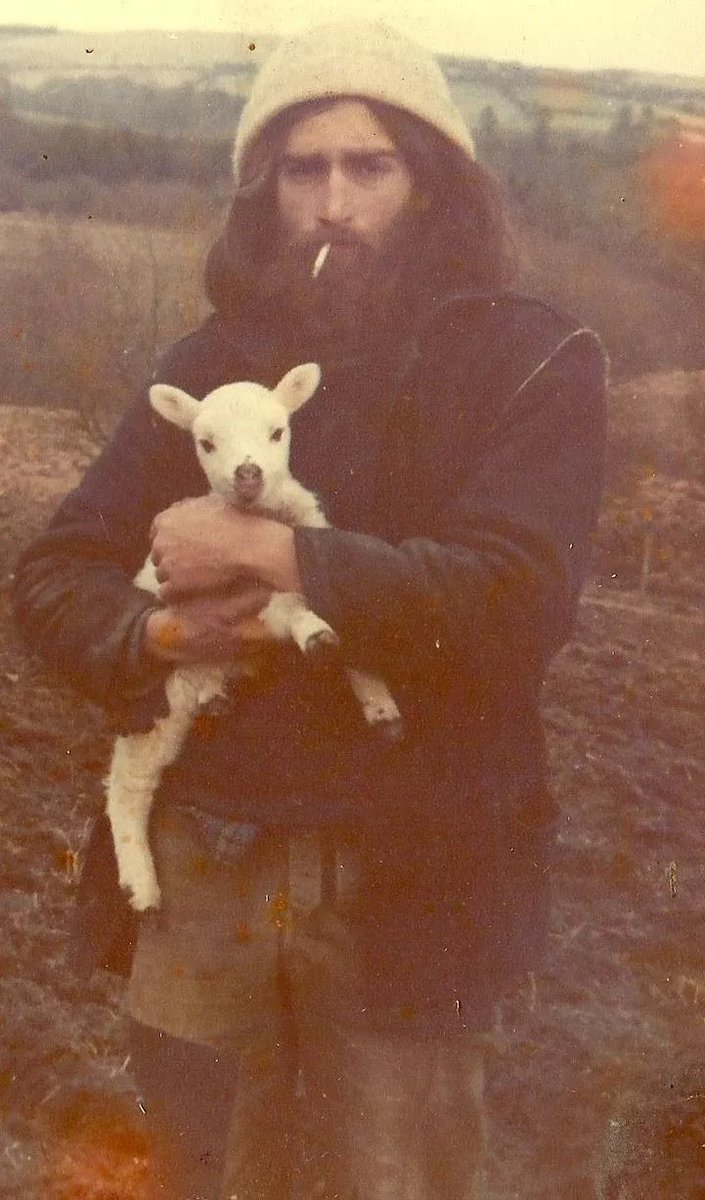 sonnysehra's tweet image. a welsh hippie smoking a cigarette with a sheep (c. 1970s)